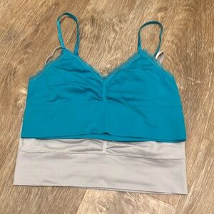 Set of 2 bralettes, one teal, one gray.